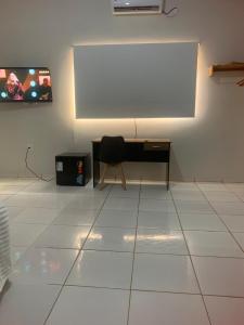 a white room with a desk and a chair at The Riverside in Novo Acordo