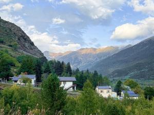 a view of a valley with mountains and houses at Studio cosy proche départ station de ski in Porté-Puymorens