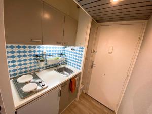 a small kitchen with a sink and a sink at Studio cosy proche départ station de ski in Porté-Puymorens +12 photos