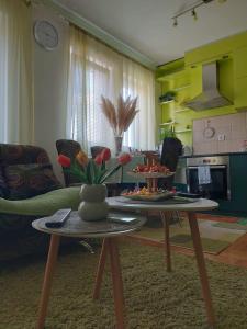 a living room with a table with flowers on it at Stancicmilena in Požarevac