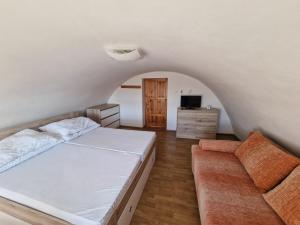 a bedroom with a bed and a couch at Chata Horec in Štrba
