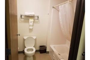 a bathroom with a white toilet and a sink at Bilmar Inn & Suites by Hotel O Hwy 77 in Dell Rapids +22 photos