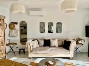 a living room with a couch and some mirrors at Tierra Fina Malaga in Cómpeta +16 photos