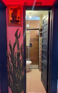 a bathroom with a cactus painted on the wall at A breath of fresh air in Belém in Belém