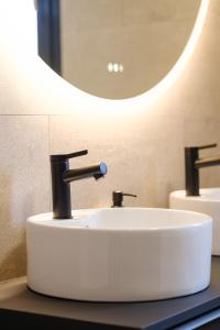 a bathroom with a white sink and a mirror at Villa neuve 2025 - Calme & Confort, 8 pers, JURA  +20 photos