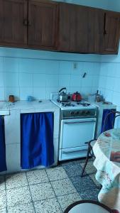 a kitchen with a stove with pots and pans on it at Sil-Cris-Mar in Carhué