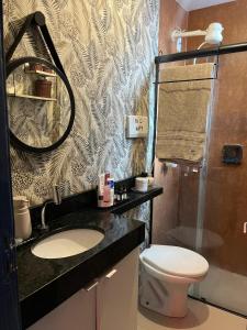 a bathroom with a toilet and a sink and a mirror at A breath of fresh air in Belém in Belém