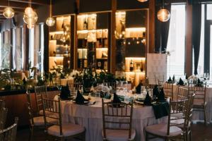 a table set up for a wedding with green napkins at Golf Forest Creek Villas in Zavidovići +29 photos