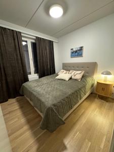 a bedroom with a large bed in a room at Lapland Apartments with private sauna, wifi and parking next to the railway station in Rovaniemi