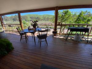 a patio with a table and chairs on a deck at Starlight Lodge in Yea