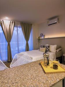 a bedroom with a bed and a table with a tray at Aparta Suite en Santamarina - Escápate al Caribe in Santa Marta