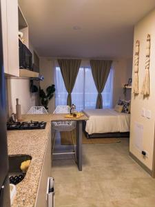 a kitchen and a bedroom with a bed at Aparta Suite en Santamarina - Escápate al Caribe in Santa Marta +12 photos