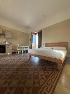 een slaapkamer met een groot bed en een eetkamer bij Casa e Cori in Acireale