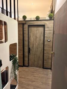 a wooden door with plants on top of a house at Le Cocoon Provençal - à deux pas de la mairie in Aix-en-Provence