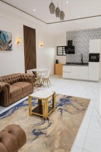 a living room with a couch and a table at CHROME Résidences Fidjrossè PLAGE in Cotonou