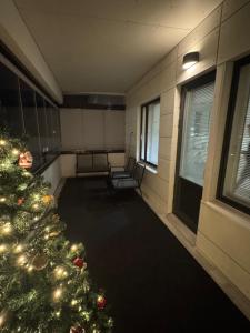 a room with a christmas tree in a room at Lapland Apartments with private sauna, wifi and parking next to the railway station in Rovaniemi