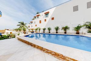 a hotel swimming pool in front of a building at Torre Malibu, Loft # 805 in Puerto Vallarta
