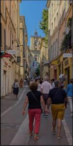 a group of people walking down a city street at Le Cocoon Provençal - à deux pas de la mairie in Aix-en-Provence +2 photos