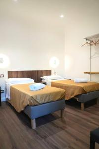 a room with two beds in a room at Mimi family in Florence