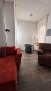 a living room with a couch and a chair at Departamento moderno con wifi y AC in Ciudad del Carmen