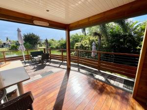 a view from the deck of a house at BUNGA-LODGE (bungalow 4* avec piscine privée) in Douville