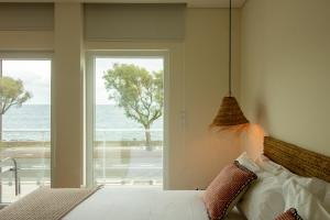 a bedroom with a bed with a view of the ocean at Bay House in Ponta Delgada