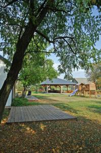 a park with a tree and a playground at Siedlisko Czerniówka in Paprotnia