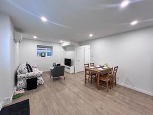 a living room with a table and a chair at Kris Anclam in Langley