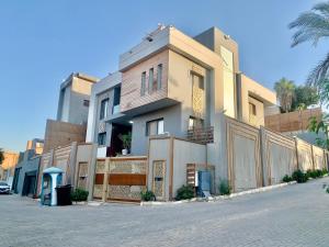 a building on the side of a street at Spacious Luxury 5BR Villa with Private Pool near GEM in Kafr Ghaţāţī