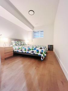 a bedroom with a bed and a wooden floor at Kris Anclam in Langley