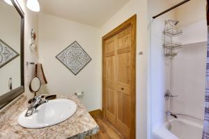 a bathroom with a sink and a shower and a door at McJuggers Loft Walk to Lake, Park, Restaurants in Campbellsport