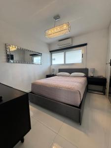 a bedroom with a large bed and a mirror at Dominik luxury penthouse in Cancún +14 photos