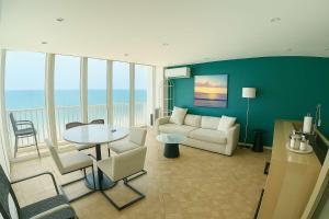 a living room with a couch and a table at Beachfront Stella Maris Apt on Condado Ave in San Juan +20 photos