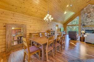a dining room with a wooden table and chairs at Luxury Cabin in The Reserve at Boyne Mountain in Boyne Falls