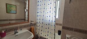 a bathroom with a sink and a mirror at Rooms Tourist Apartment in Huelva +24 photos