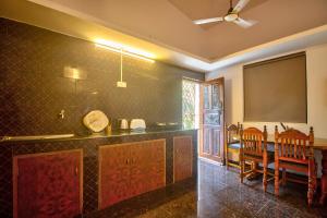 a kitchen with a counter and a table and chairs at Anjuna House With Ocean View in Anjuna