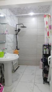 a white bathroom with a sink and a shower at Constantine in Constantine