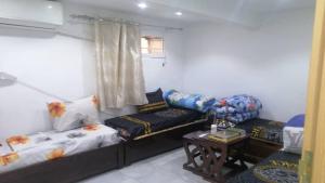 a living room with two beds and a table at Constantine in Constantine +4 photos