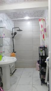 a white bathroom with a shower and a sink at Constantine in Constantine