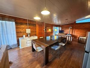 a kitchen and dining room with a table and chairs at Macondo in Sauce de Portezuelo +3 photos