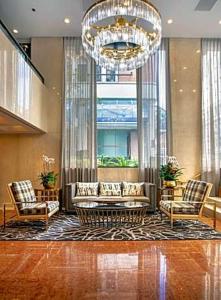 a lobby with a couch and two chairs and a chandelier at The Donatello in San Francisco