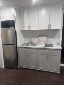 a kitchen with a stainless steel refrigerator and a sink at So cute so cozy in Elizabeth