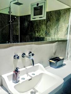 a bathroom with a white sink and a mirror at Madaro House in San Antonio de Arredondo +13 photos