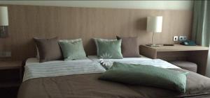 a large bed with two pillows on top of it at Hotel Concordia in Euskirchen