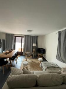 a living room with a couch and a table at Star Résidence in Isola