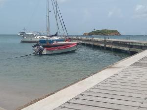 a boat is docked next to a dock at Villa Soussoute - à 2mn de la plage de Tartane in La Trinité