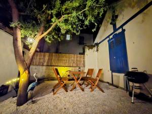 a room with a table and chairs and a tree at L'Ombre du Hêtre in Lourdes +10 photos