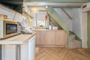 a kitchen with a staircase in a tiny house at Charming Welsh Cottage in Dolgellau - Snowdonia in Dolgellau +13 photos