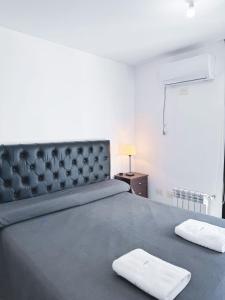 a bedroom with a large bed with two towels on it at Edificio PRISMA I in Villa Carlos Paz +69 photos