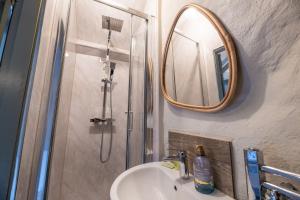 a bathroom with a shower and a sink and a mirror at Charming Welsh Cottage in Dolgellau - Snowdonia in Dolgellau